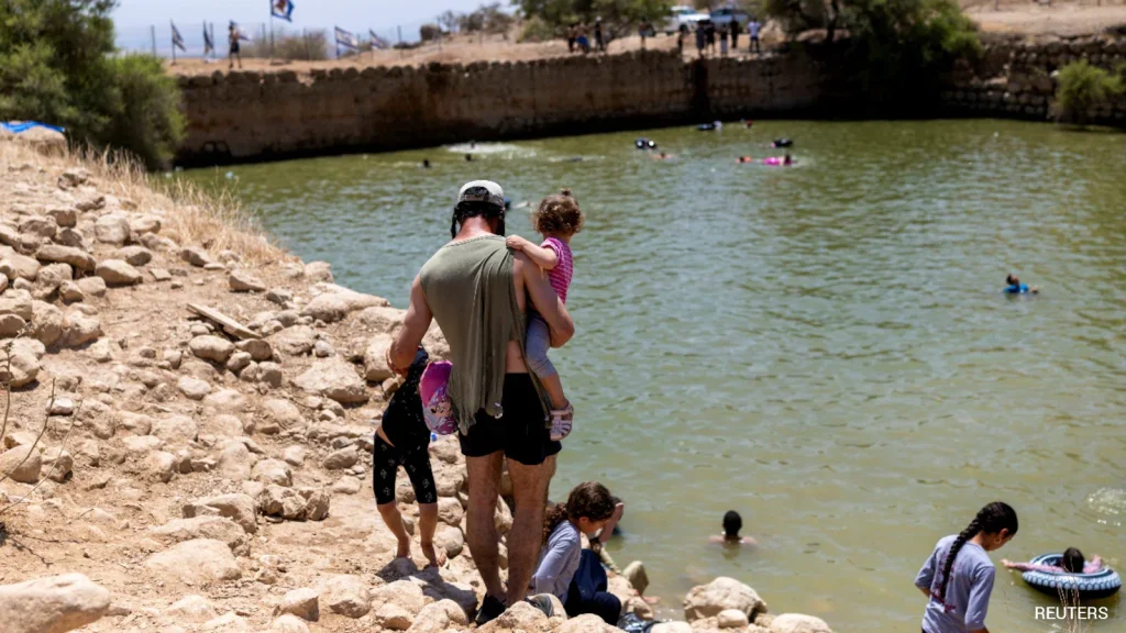 On a searing summer day, Israeli settlers splashed in a West Bank pool created by siphoning off water