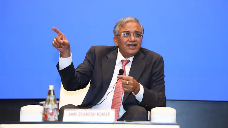 Addressing an audience of prominent citizens, academic leaders, and election officials
