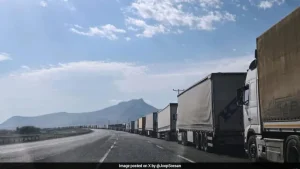 Hundreds of trucks idle along the road into Iran from Turkey's mountainous eastern border