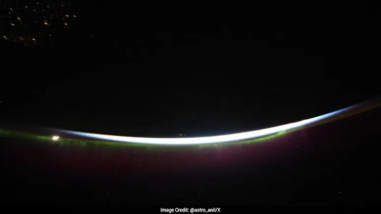 A video shared on X by Astronaut Anil Menon shows a purple aurora lighting up the night sky