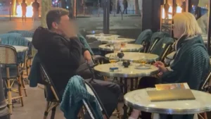 Couple Enjoys Drinks In Paris As Fires Rage Nearby Amid Protests In France