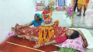 Madhumala Devi is lying on a bed fitted with 2,516 sharp nails as part of her worship